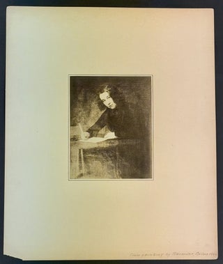 MOUNTED SILVER GELATIN PHOTOGRAPH Of A YOUNG DICKENS, Seated at a Writing Table, Facing to His Left.